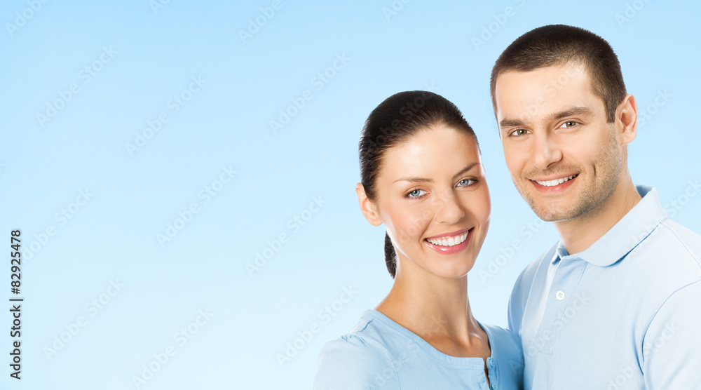 Portrait of young couple, on blue, with copyspace Portrait of young couple, on blue, with copyspace