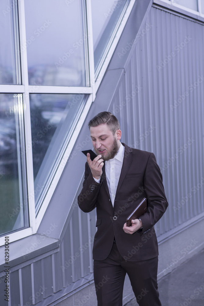 young businessman talking on the phon, aggressive young businessman talking on the phon, aggressive