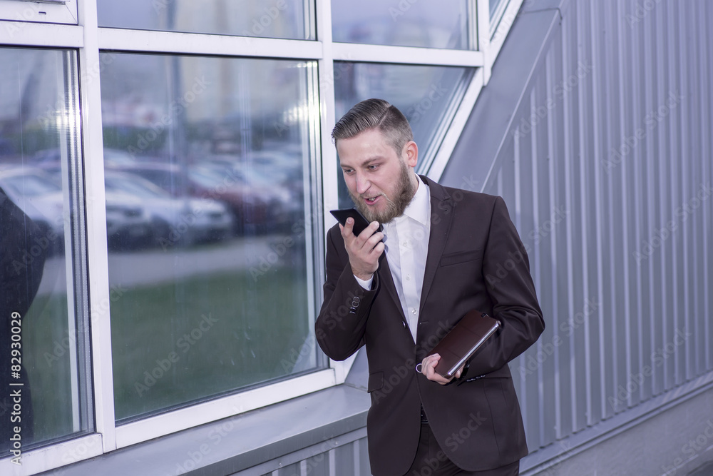 young businessman talking on the phon, aggressive young businessman talking on the phon, aggressive