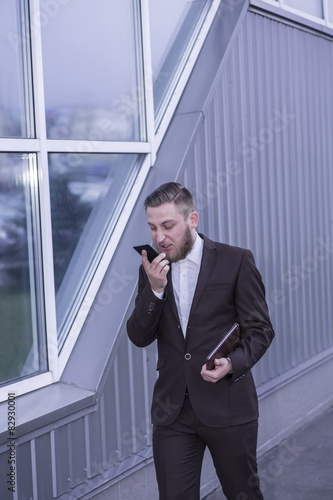 young businessman talking on the phon  aggressive