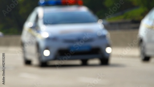  Two police cars with flashing lights in blur