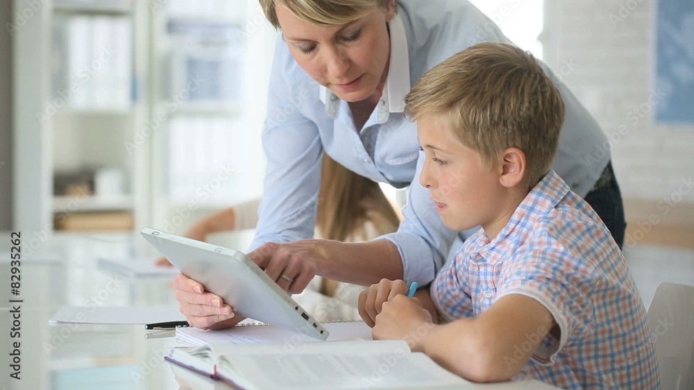 Teacher using digital tablet as educational tool in class