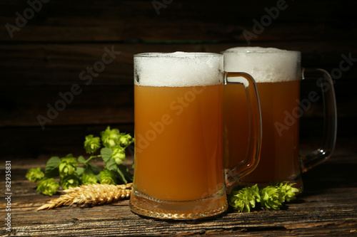 Mug of beer on a brown wooden background