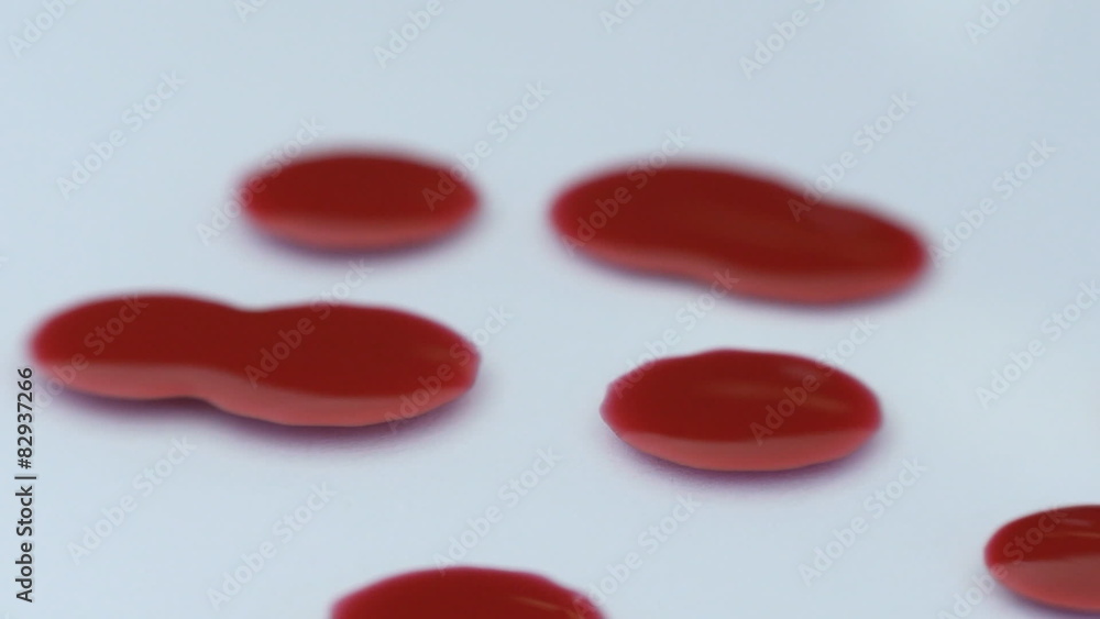 Falling drops of blood transfused in colorful rays of light. Falling drops of blood transfused in colorful rays of light.