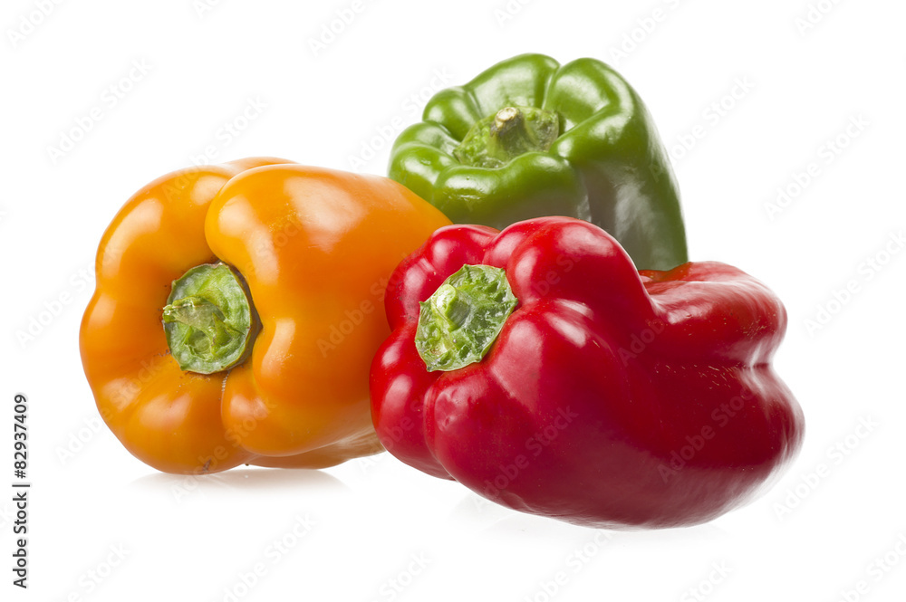 colored peppers close up over white background