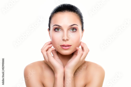 Beautiful young woman with fresh clean skin hands touching face.