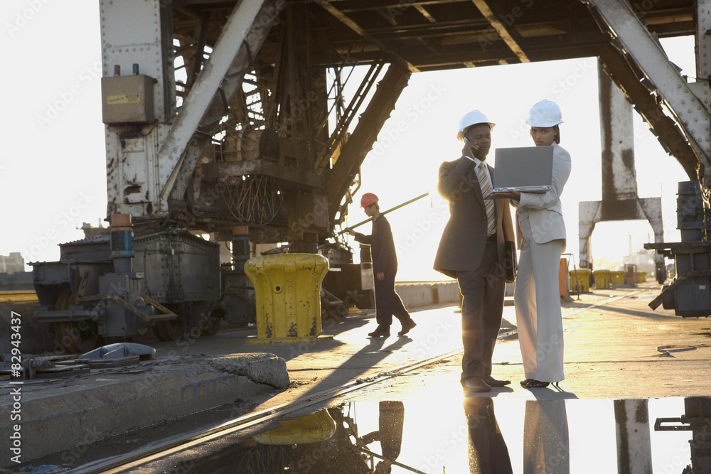 African American businesspeople wearing hardhats African American businesspeople wearing hardhats
