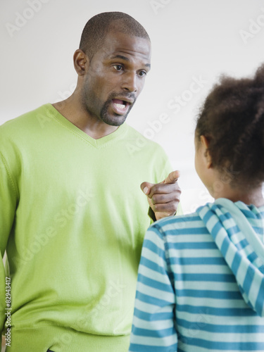 African father scolding daughter photo