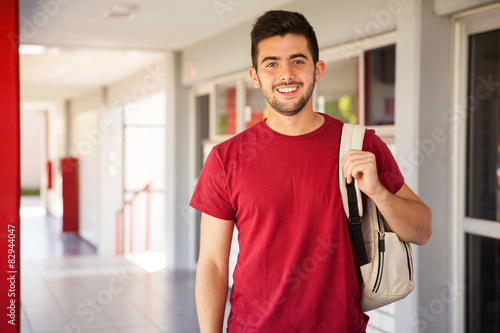 Portrait of a Latin college student standing in a hallway