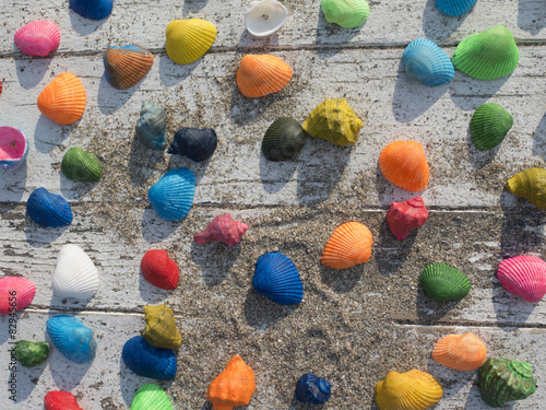 background of seashells on a white table with sand photo