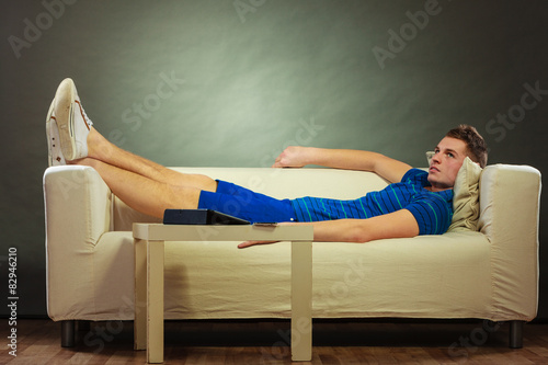 Принти на полотні Young man relaxing on couch