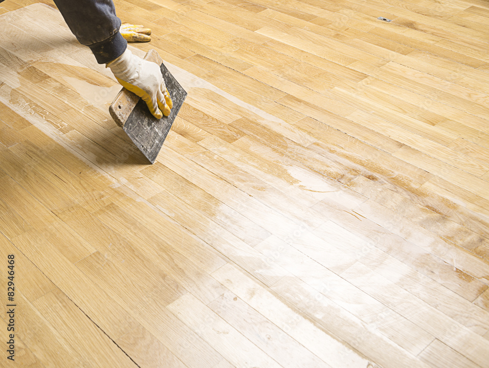Varnishing parquet floor with space for your text. - obrazy, fototapety, plakaty 