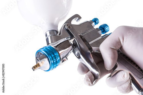 Spray gun in hand isolated on white