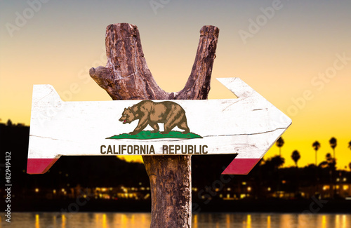California Flag wooden sign with sunset background photo