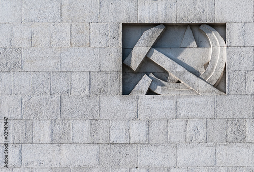 Fotografi Symbols of USSR on gray brick wall of soviet era building