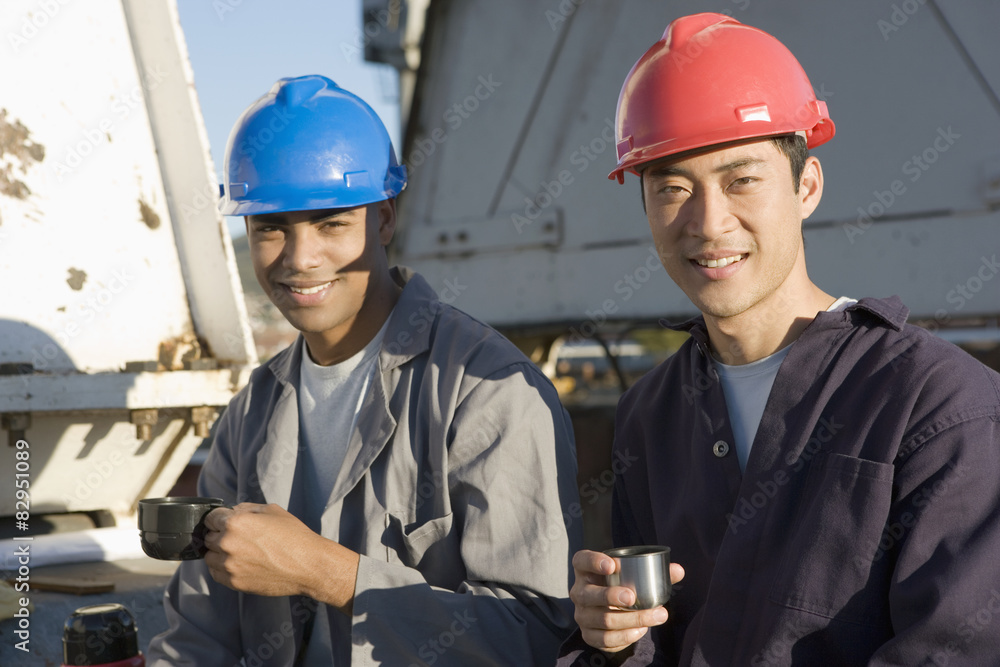 Multi-ethnic male construction workers drinking coffee Multi-ethnic male construction workers drinking coffee