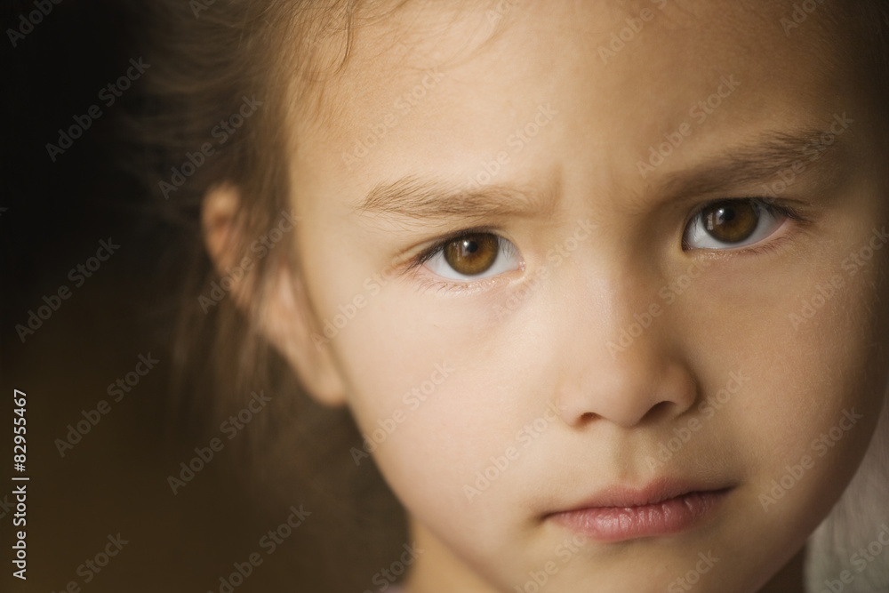 Close up of Asian girl with furrowed brow Close up of Asian girl with furrowed brow