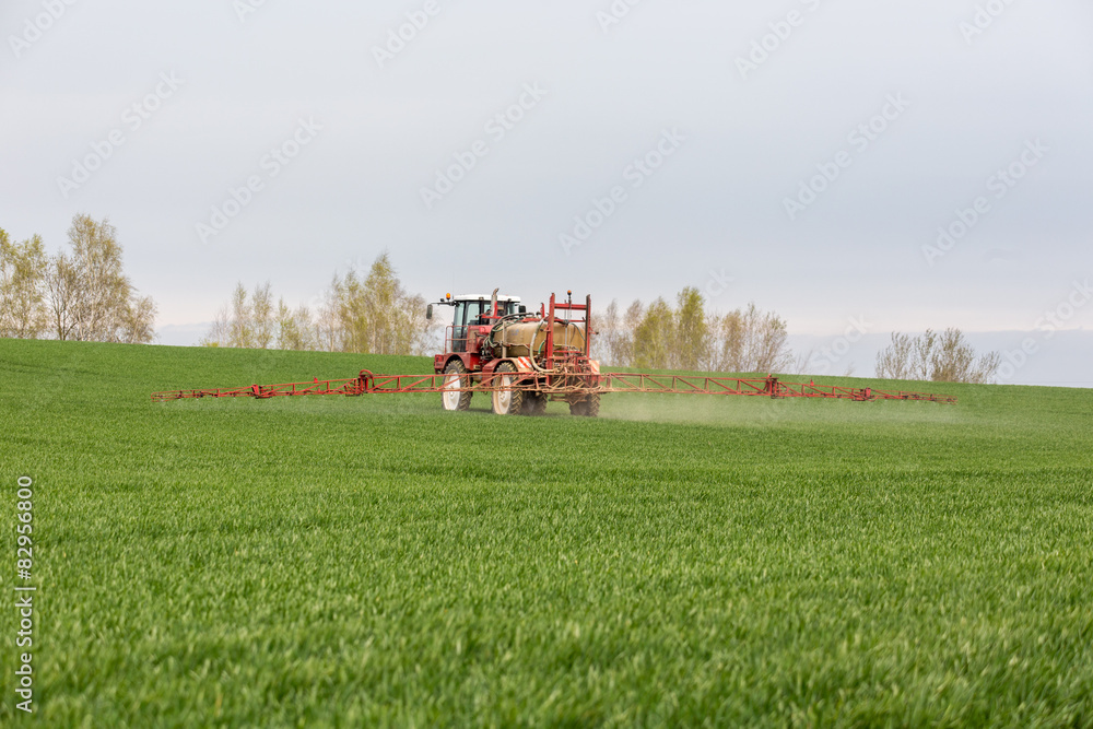 Spraying the herbicides on the green field Spraying the herbicides on the green field