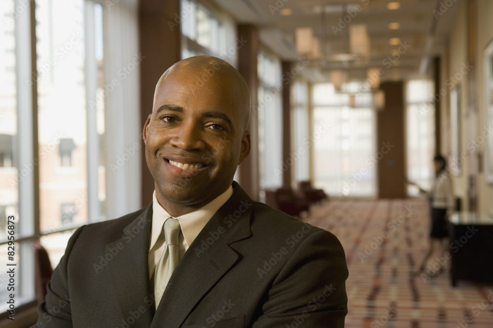 African businessman smiling in hotel corridor African businessman smiling in hotel corridor