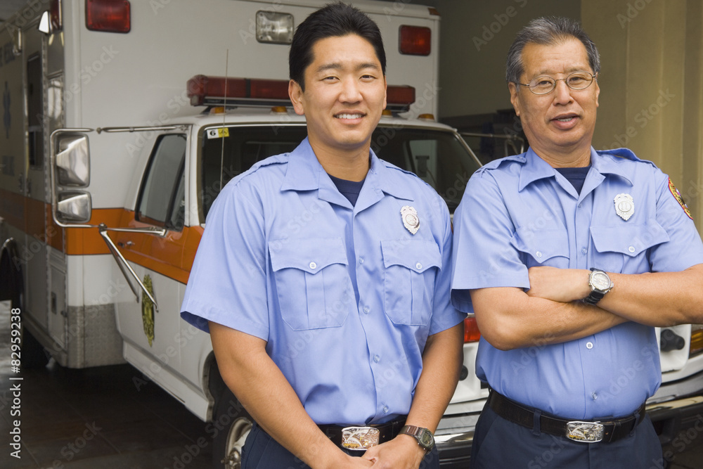 Asian male paramedics in front of ambulance Asian male paramedics in front of ambulance