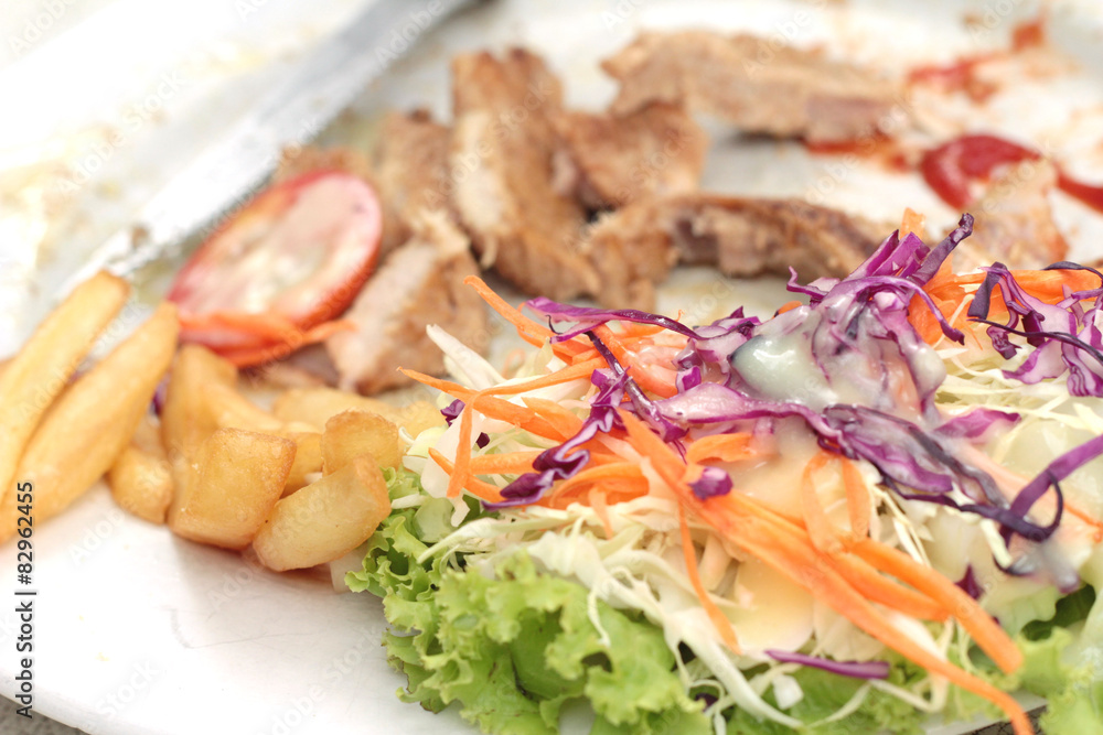 steaks and vegetable salad with french fries. steaks and vegetable salad with french fries.