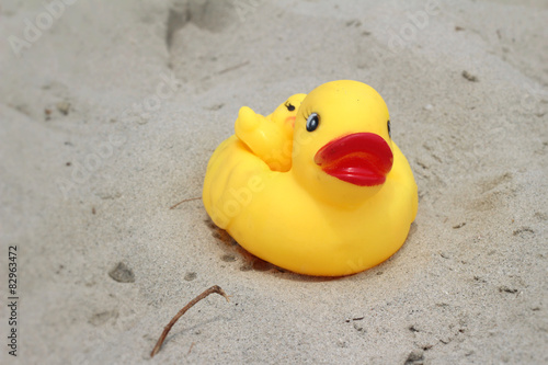 Lovely of yellow rubber duck on the sand.