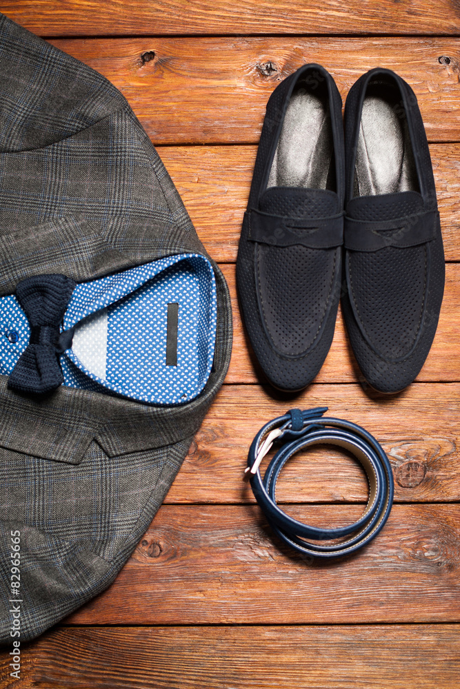 Men's suit, belt and footwear on a wooden background Men's suit, belt and footwear on a wooden background