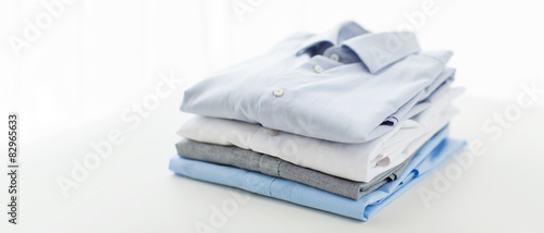 Fotografie close up of ironed and folded shirts on table