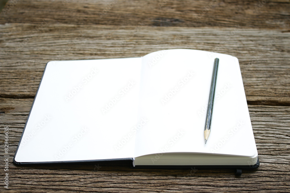 Fototapeta premium Notebook on wooden table