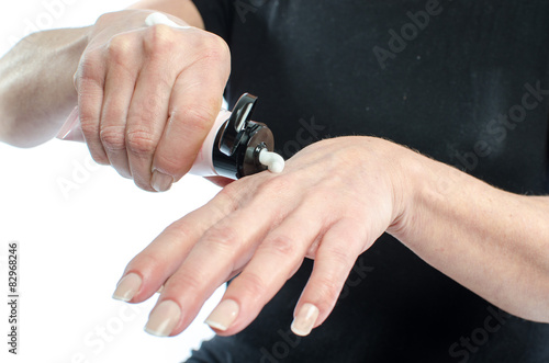 Woman putting cream on her hand