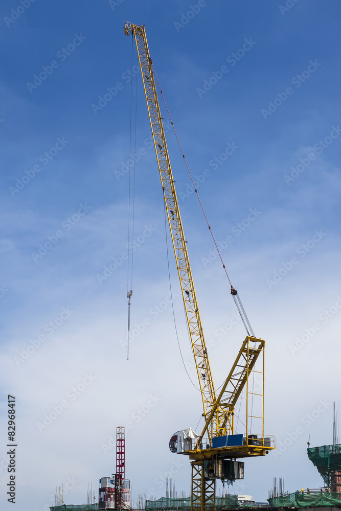 Industrial Crane and construction site with blue sky