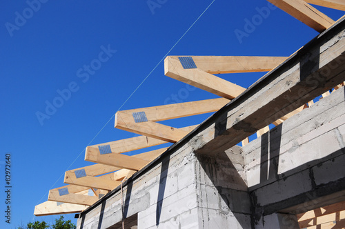 Installation of wooden beams at roof construction  photo