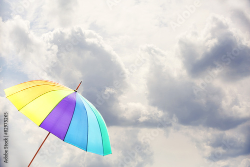 Colorful umbrella on sky background