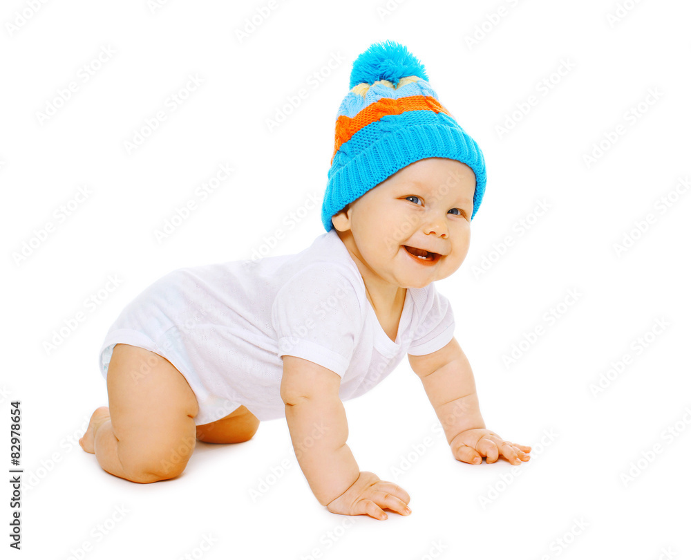Laughing positive little baby crawls in the knitted hat Laughing positive little baby crawls in the knitted hat