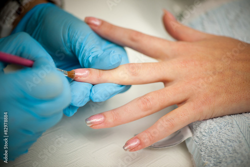 Making hand nails in a professional hand care salon - manicure