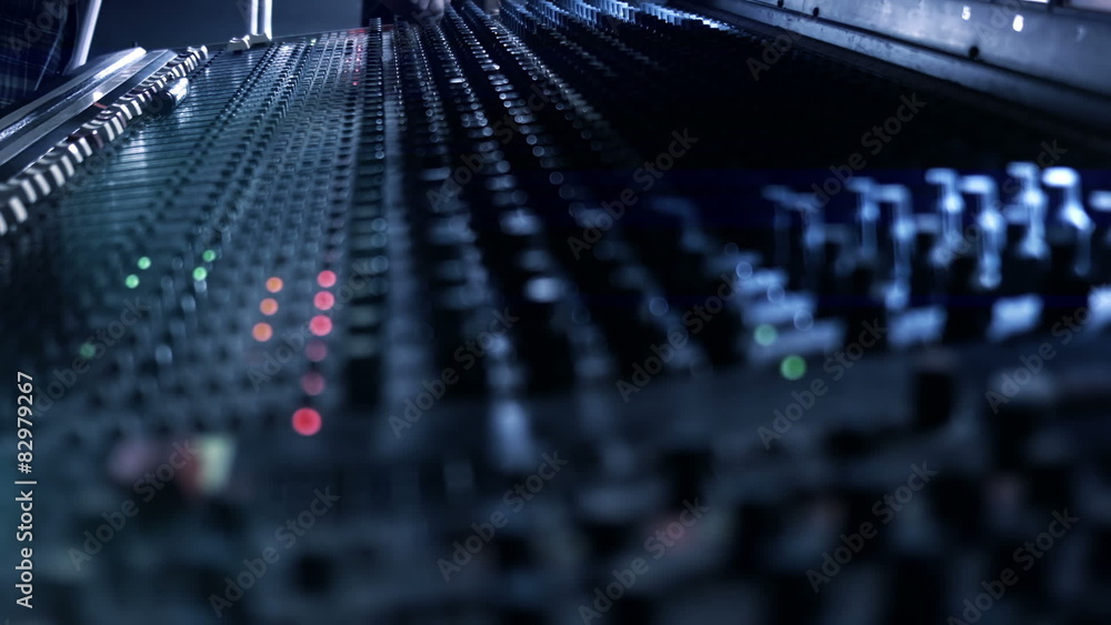 Audio Engineer adjusting knobs and faders on mixing console desk Audio Engineer adjusting knobs and faders on mixing console desk
