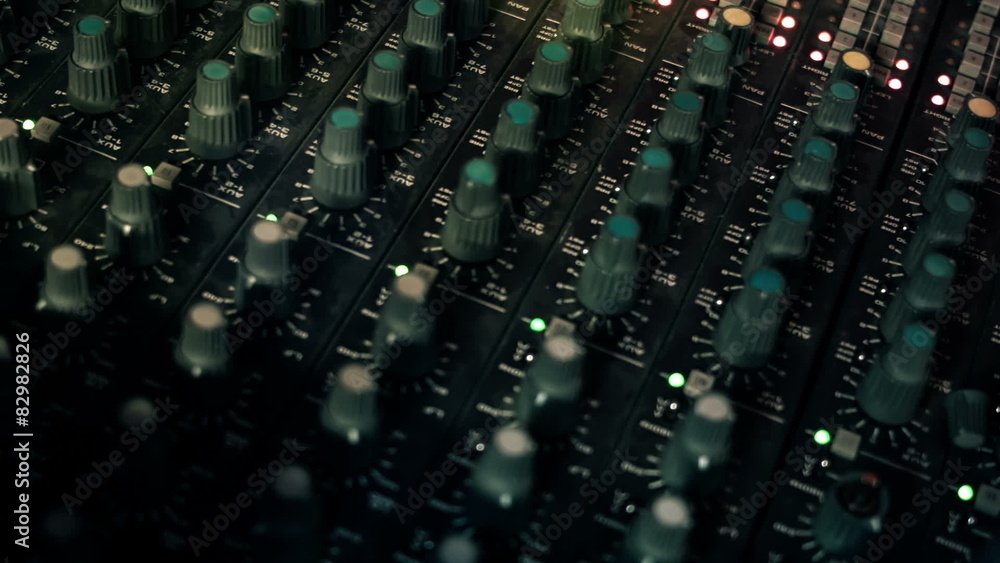 Close-up panning shot of EQ Knobs on a mixing console desk Close-up panning shot of EQ Knobs on a mixing console desk