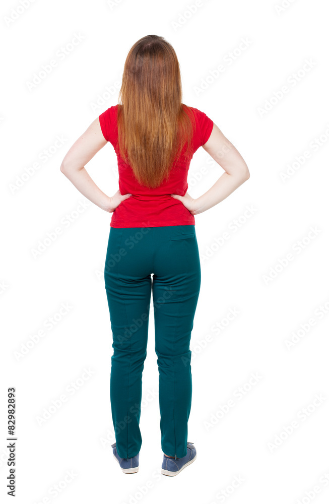 back view of standing young beautiful woman in jeans. back view of standing young beautiful woman in jeans.