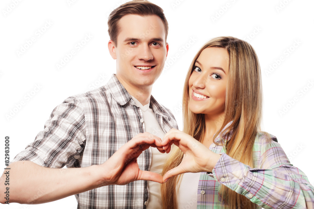 Happy couple showing heart with their fingers Happy couple showing heart with their fingers