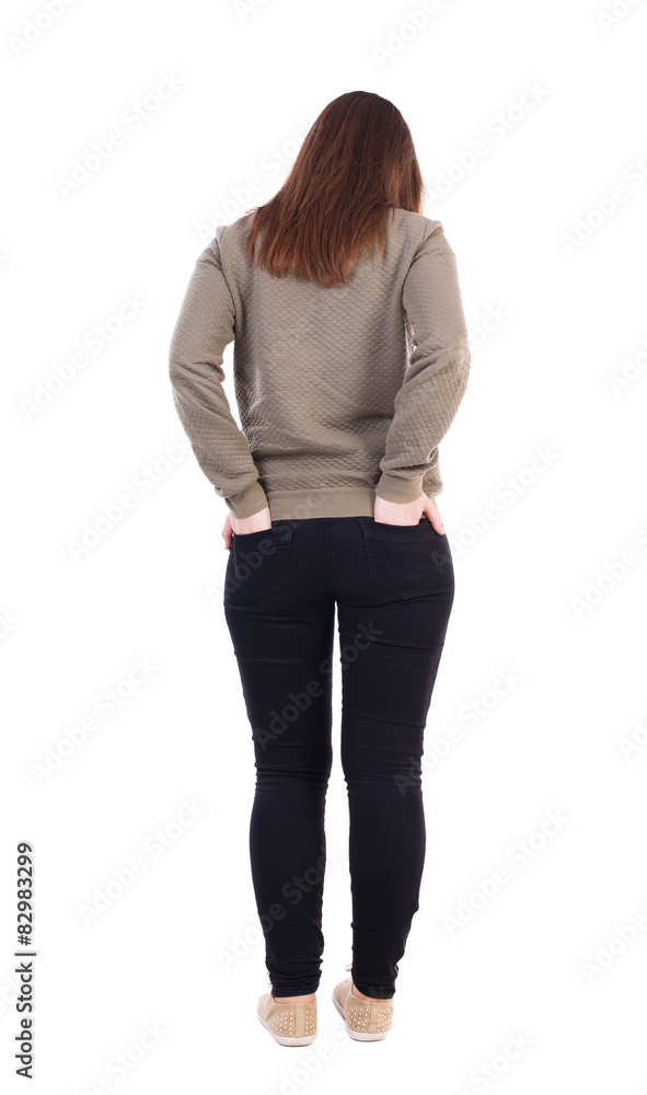 back view of standing young beautiful woman in jeans. back view of standing young beautiful woman in jeans.