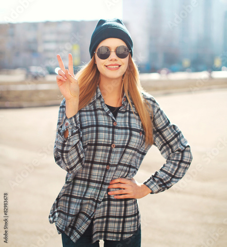 Fashion outdoor portrait of pretty cool girl having fun in sunny © rohappy