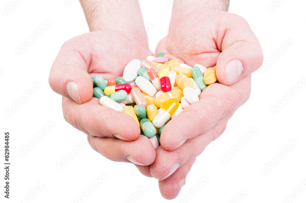 Both hands holding bunch of pills