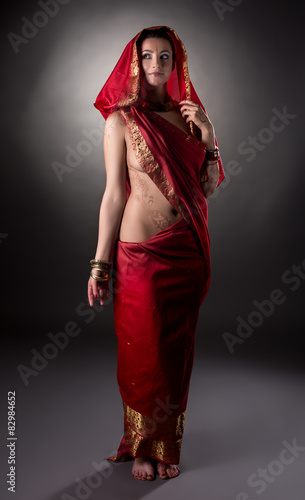 Mehndi. Charming model posing semi-nude in sari