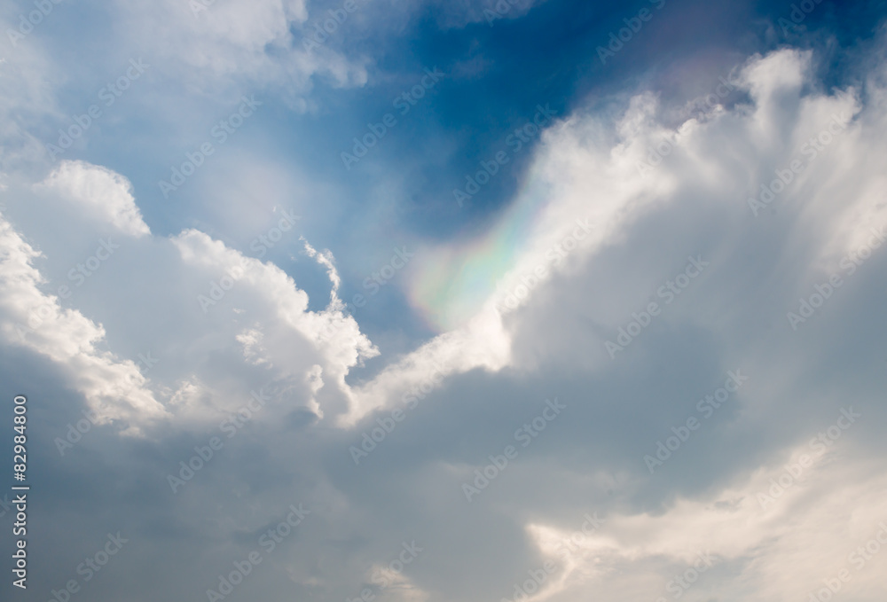 cloudy blue sky with light of rainbow color. cloudy blue sky with light of rainbow color.