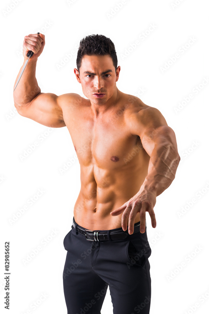 Muscular man holding big knife ready to stab