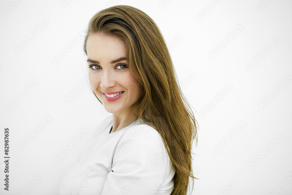 Beautiful young happy woman posing against a white wall Beautiful young happy woman posing against a white wall