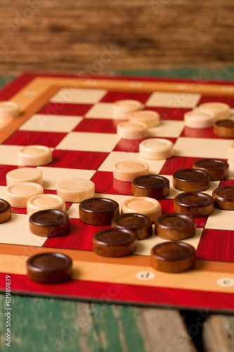 Wooden stones on board for Game of Checkers