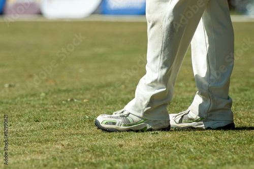 cricketer legs in traditional white trousers