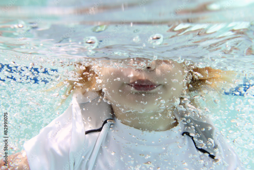 Fototapeta premium Child Swimming in Pool Underwater