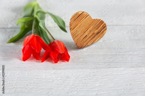 Tulips and wooden heart